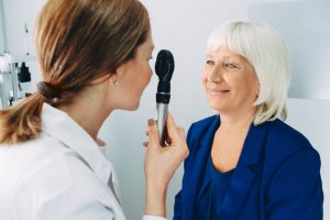 Ophthalmologist examines senior woman